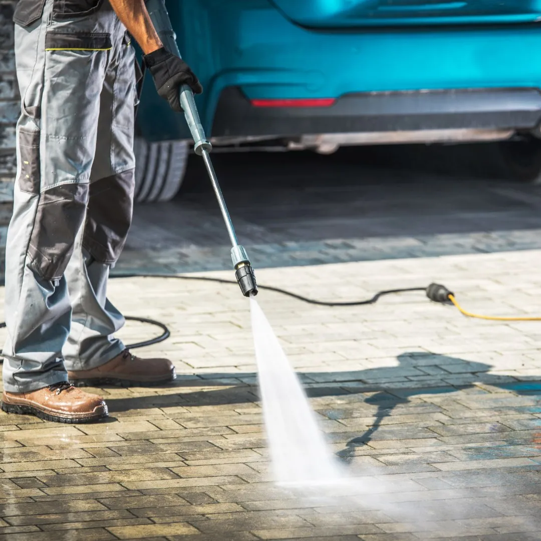 Pressure washing a paver driveway
